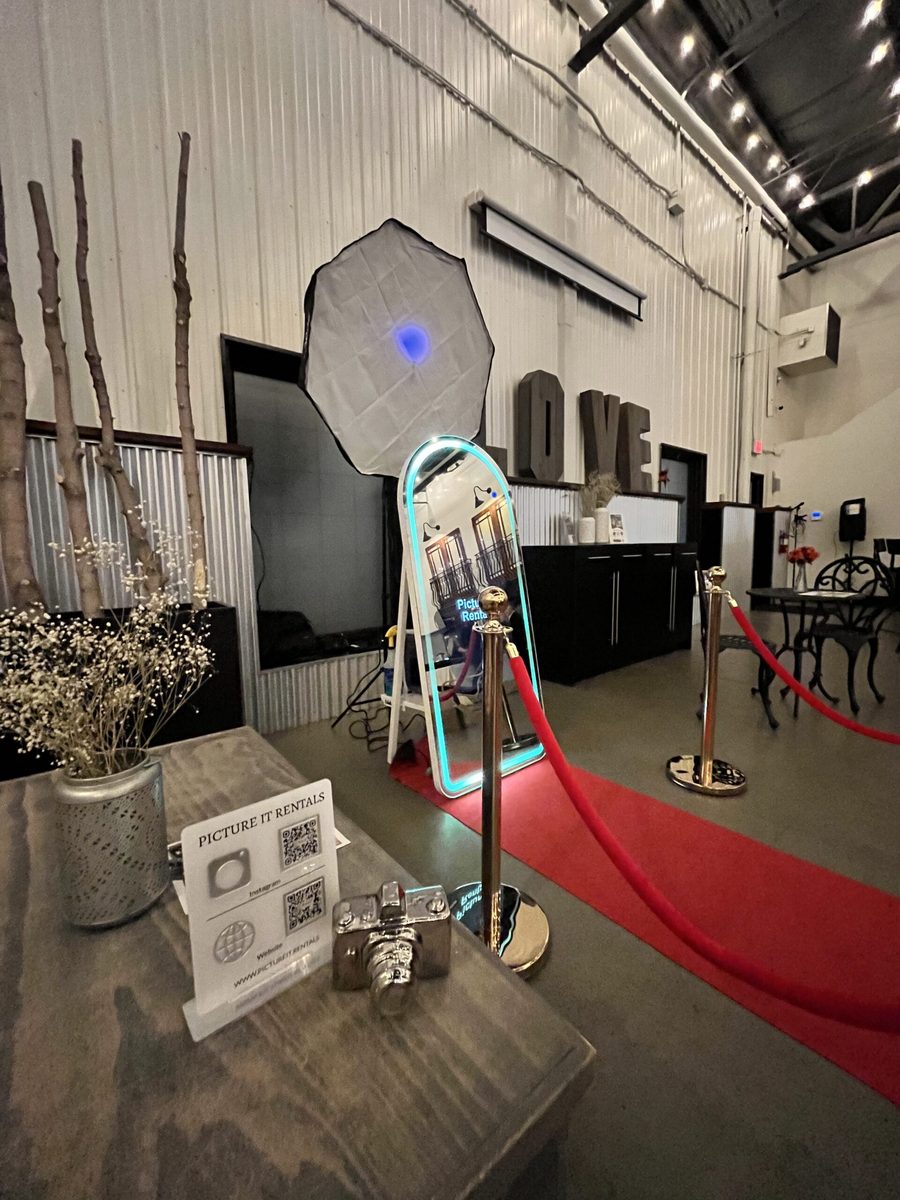 The Picture It mirror booth with gold stanchions and a red carpet at an Edmonton venue