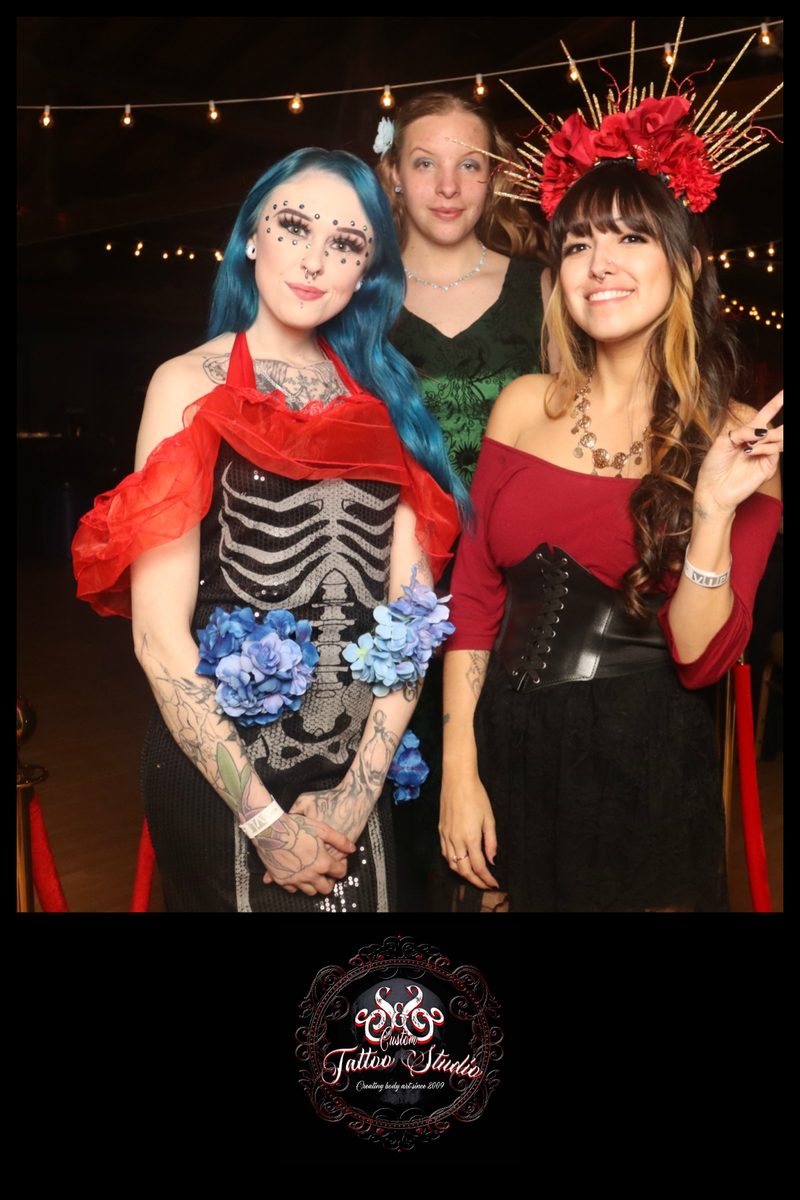 Guests in costume posing at the mirror booth