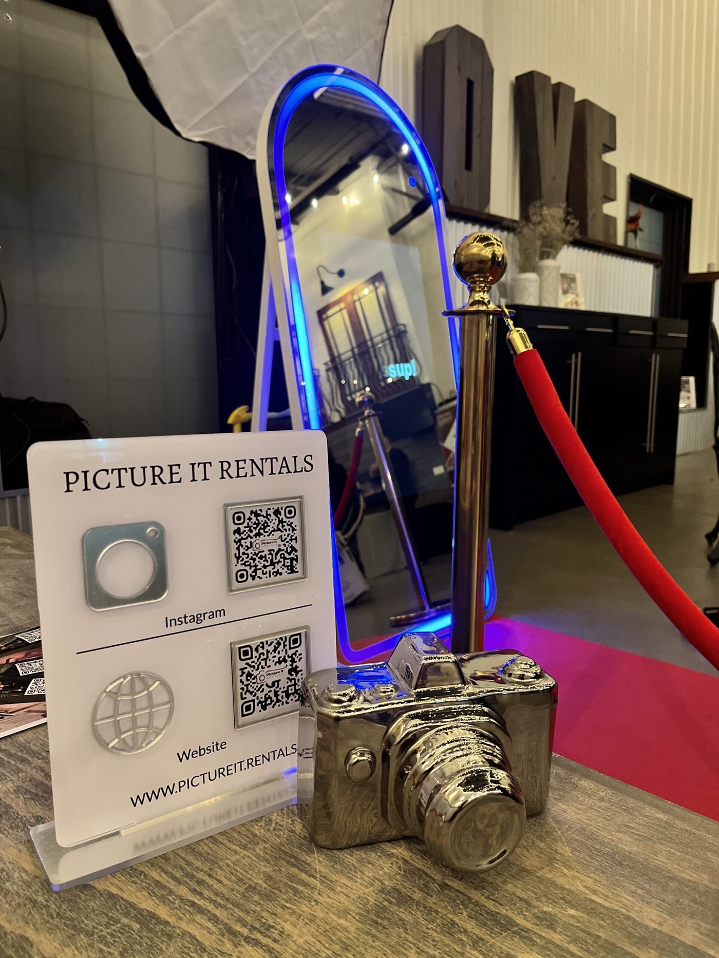 The mirror booth set up with stanchions and a red carpet at a venue